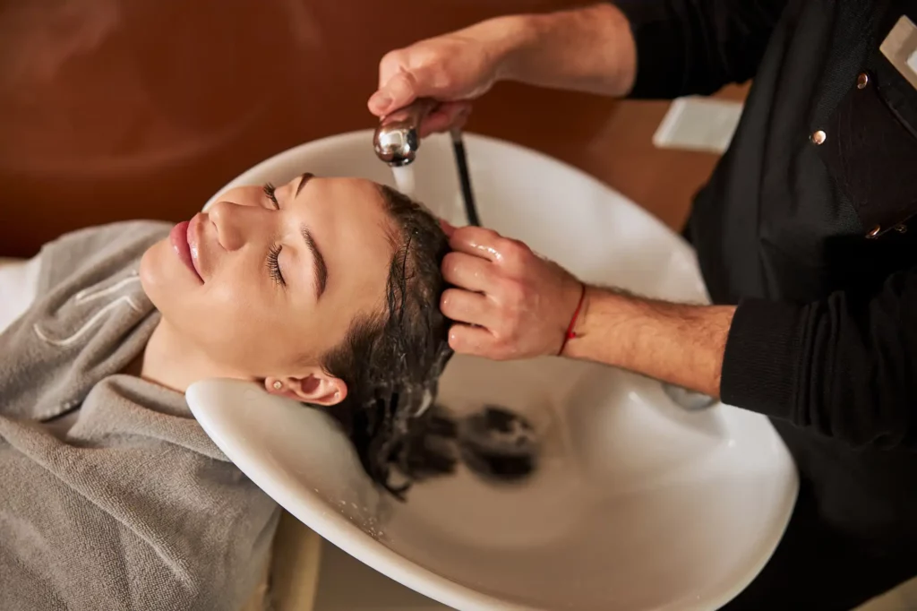 olaplex treatment tranquil woman having her hair washed at a salon
